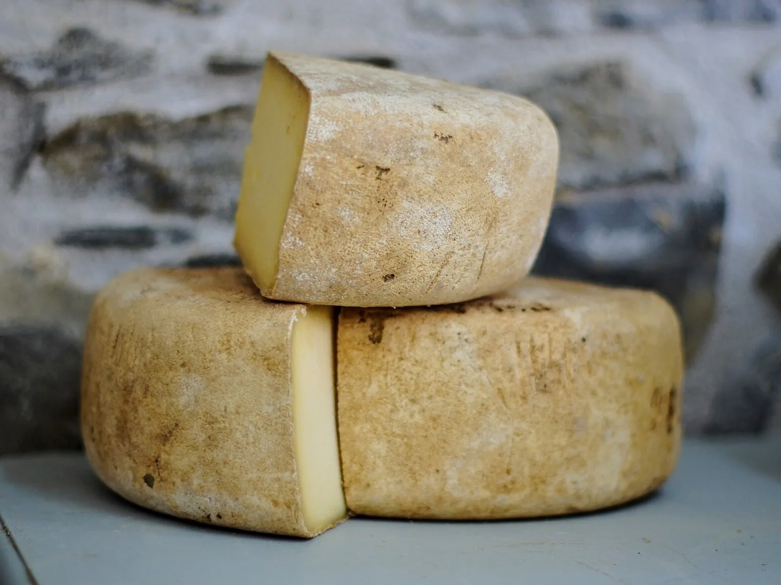 Cut wheels of natural-rind farmhouse cheese